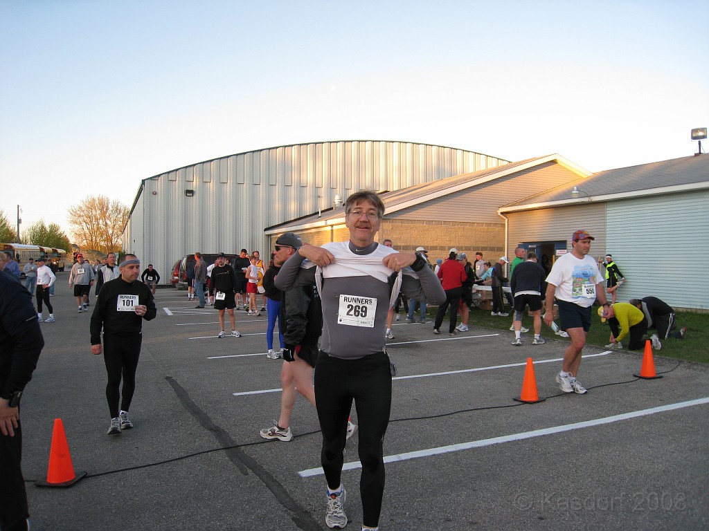 Mackinaw Island Area May 2008 0088.jpg - Where are the cops.... it's a flasher!! No, just showing official number. When race started it was 38 degrees... I wore second shirt to keep warm. It was nice at the start, at mile one I wished I had gloves, at mile 3 I was ready to take both shirts off, at mile 4+ I didn't really care much anymore either way. I was just concentrating on getting to the timing lights.